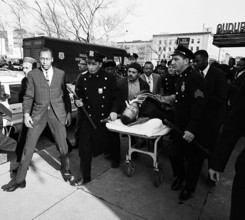 Malcolm X is taken away from the Audubon Ballroom on a stretcher after being shot in 1965. Malcolm X born Malcolm Little, later el-Hajj Malik el-Shabaz was an African American revolutionary, Muslim mi...