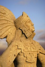 A statue of Cuauhtemoc glows in the sunset in Ensenada Baja California Mexico