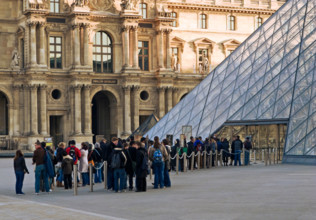 Louvre Museum, Paris, France, Europe - Visitors queue up early in the morning at the Louvre Pyramid entrance