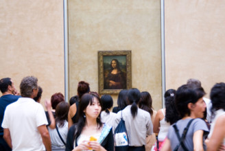 Crowds of visitors looking at the Mona Lisa by Leonardo da Vinci in the Louvre Paris France