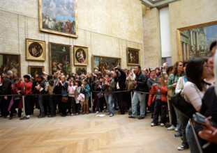 Tourists taking pictures of the Mona Lisa in The Louvre in Paris