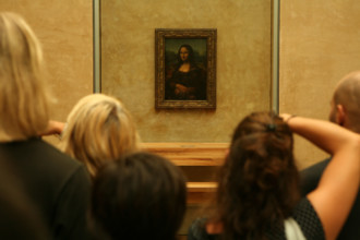 Visitors taking pictures of Mona Lisa by Leonardo da Vinci in the Louvre Museum in Paris, France.