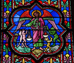 Stained glass window depicting Saint Michael the Archangel at the Final Judgement, in Bayeux, Calvados, France