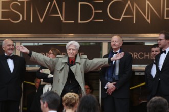 French director Alain Resnais welcomes his cast from the top of the stairs at the premiere of "You Ain't Seen Nothin' Yet" during the 65th Cannes Film Festival at Palais des Festivals in Cannes, Franc...