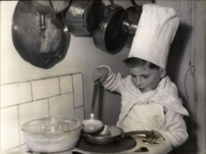 Jan. 31, 1954 - Ready for Candlemas: After watching Mammy doing the Pancakes, Little Francois has a try. White apron and chef's