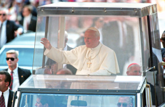 Pope John Paul II waves from inside the popemobile during his visit October 8, 1995 in Baltimore, Maryland.