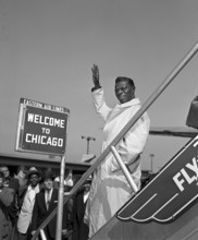 Nat King Cole arriving at Chicago Airport onto the tarmac among a crowd. April 11, 1956.  Original camera negative.