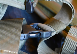 Closeup of nylon backpack with plastic straps, belts and clips