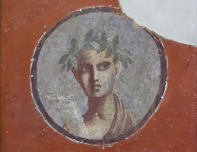 Medallion with a male portrait of a young poet awarded a garland for taking part in a literary contest depicted in the Roman fresco from the House of the Cenaculum (Casa del Cenacolo) in Pompeii (1-79...