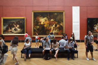 Visitors in front of the painting 'Death of Sardanapalus' (1827-1828) by French Romantic painter Eugène Delacroix displayed at his retrospective exhibition in the Louvre Museum in Paris, France. The e...