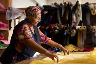 Middle aged woman working at a hat factory