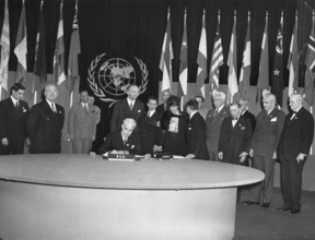 San Francisco, California:  June 26, 1945 President Truman (second from left) looks on proudly as Secretary of State Edward Stettinus signs the United Nations Charter.