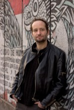 Jan 19, 2006; Mexico City, MEXICO; Mexican film maker, CARLOS REYGADAS' work is quintessentially Mexico City, here photographed in front of a decomposing mural on the streets of the historical center ...