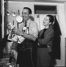 Christopher Lee actor with his wife Gitte Lee March 1962 watching him do the wiping up