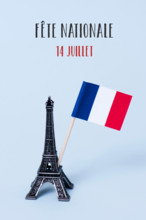 a miniature of the Eiffel Tower, a french flag and the text fete nationale 14 juillet, the national day of France written in French, against a pale bl