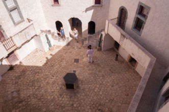 Tourists walking in the interior courtyard of La Citeadelle museum, Saint Tropez, France