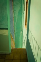 Detail of a pastel green staircase with shadows, Havana, Cuba