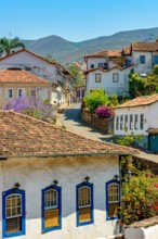 Quiet street with old colorful houses in colonial architecture, cobblestones and lanterns for lighting at Ouro Preto city