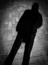the hard shadow of man at night outdoors