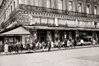 1960s CAFE DE LA PAIX ON PLACE DE L'OPERA AND RUE DE LA PAIX PEDESTRIANS AND DINERS AT OUTDOOR CAFE TABLES PARIS FRANCE - r18865 MAY001 HARS REAL ESTATE DE STRUCTURES CITIES GOURMET EDIFICE OPULENT 9T...