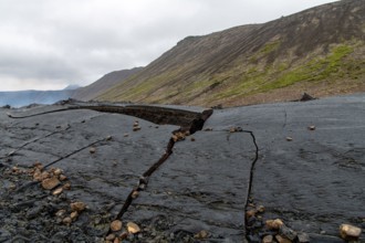 Close up view of cracked lava crust or ingenious rock, cooled down from 2021 eruption of volcano Mt. Fagradalsfjall in Geldingadalir valley on Reykjan