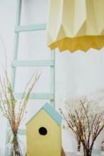 easter decoration. easter eggs with wooden feeder and mimosa.