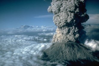 July 22, 1980 eruption of Mount St. Helens, with Mount Rainier, Washington, in the background. July 22, 1980.