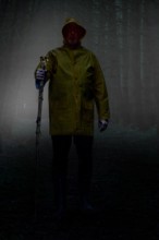 Wanderer of the night. Mysterious man walks through the forest at night.