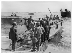 1944 WW2 St. Tropez wounded US soldiers are loaded onto a LCVP for transfer to hospital ship Invasion troops of U.S. Army establishes a beachhead in Saint-Tropez, France during World War II.  Wounded ...
