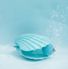 Blue sea shell and tomato with air bubbles in the water. Summer minimal concept with healthy food. Square with copy space. Isometric