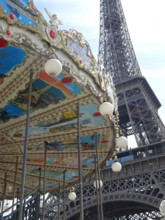 The eiffel tower in paris with the typical parisian carousel worth seeing at every season.
