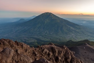 View of green Merbabu volcano from Merapi mountain. Java island, Indonesia.