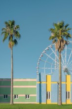 Building exterior minimal pastel colors and geometric lines with palm trees and ferris wheel on background. Abstract colorful architecture. Vertical o