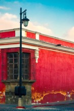 Balcony in corner house and lantern in the colonial city of La Antigua Guatemala, ancient architectural space, conservation and heritage of humanity.