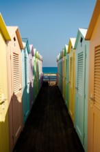 Group of colorful beach cabins in Italy.