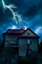 mysterious hose at night with stormy sky and lightning