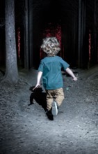A little boy runs through the night forest after an orange light