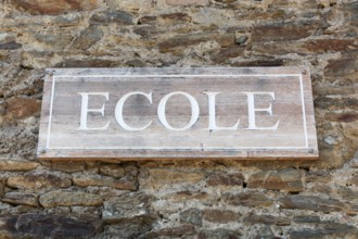 School signboard on a wall called ecole in French language