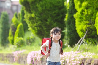 Girl walking with school bag on her back