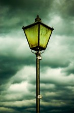 Vintage Street Lamp Against a Dramatic Overcast Sky on a Cloudy Day