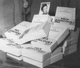 Dec 06, 1954; Unknown, UNKNOWN; (File photo) Simone de Beauvoir's portrait with copies of her book 'Les mandarins,' which won the 1954 Goncourt Prize.