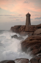 Lighthouse at Ploumanach on the Rose Granite coast Brittany France at Sunset