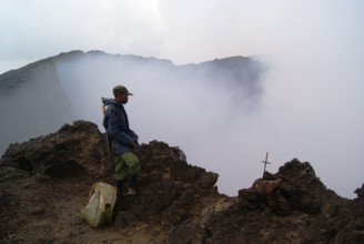 Virungas National Park, DRC: A park ranger stands at the mouth of Nyiragongo, one of the most active volcano's on earth.