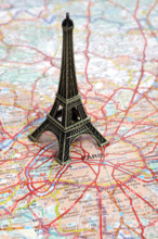 Statue of Eiffel Tower on map of Paris