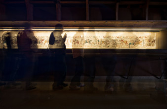 Bayeux, France. Tourists look at the famous tapestry which depicts the events leading to the Norman conquest of England in 1066.