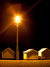 Beach Huts at Night Under a Street Light