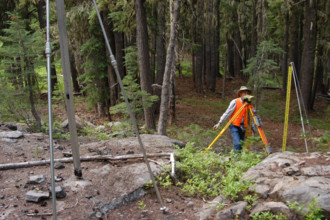 A USGS team conducts a leveling survey on a volcanic mountain on August 24, 2006. The process involves precise measurements to monitor any changes in the landscape due to seismic activity or geologica...