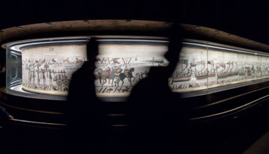 Bayeux, France. Tourists pass by the famous tapestry which depicts the events leading to the Norman conquest of England in 1066.