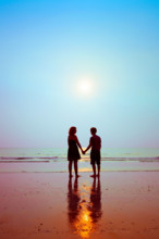 honeymoon, silhouettes of loving couple on the beach