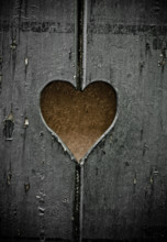 Wooden symbol - the heart cut out in boards